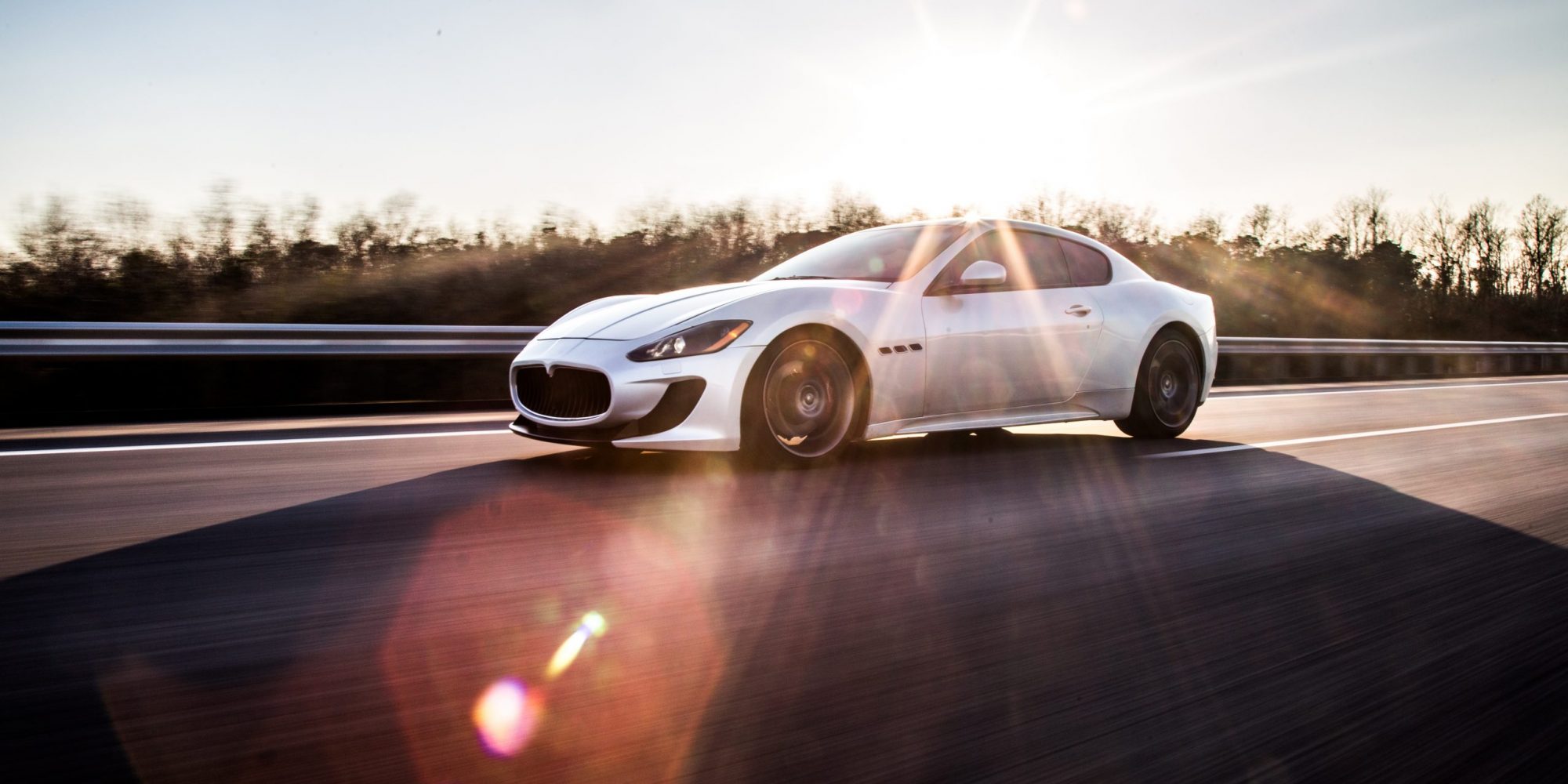 high-speed-silver-sport-car-driving-highway-sunny-weather